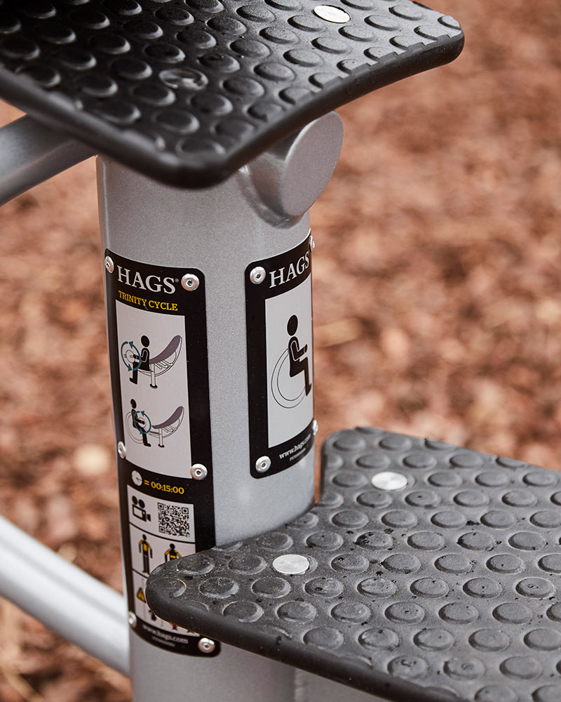 Close up of HAGS labels on outdoor fitness machines to show how to use the machine.